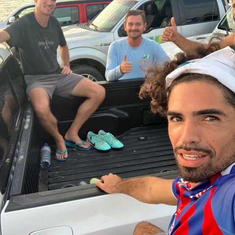 a group of people sitting around a car