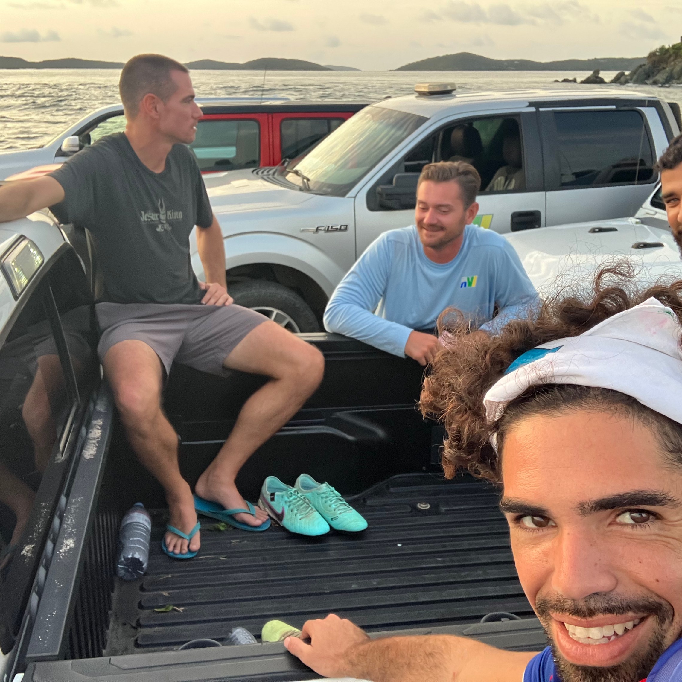 a group of people sitting around a car