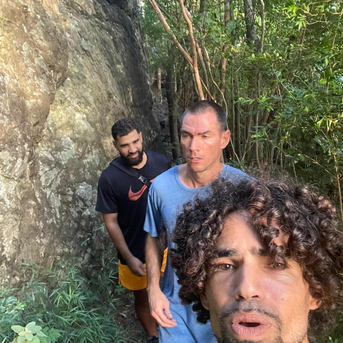 a man standing next to a tree